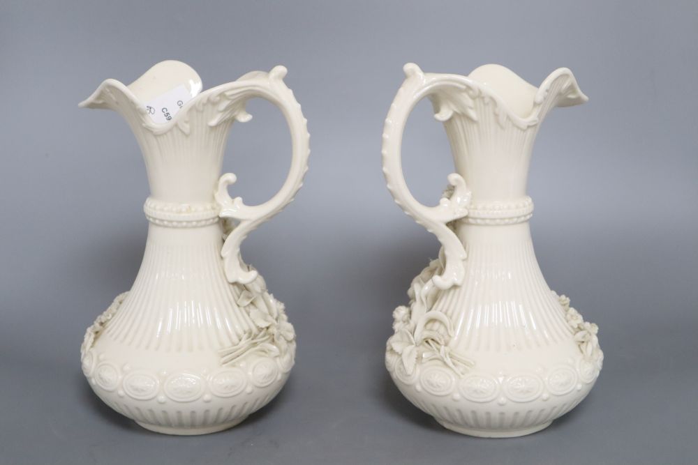 A pair of Belleek ewers, second period, height 23cm